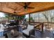 Inviting covered deck for outdoor entertainment, featuring wood floors, ceiling fans, and comfortable seating at 149 Crown Glen Way, Stockbridge, GA 30281