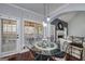 Bright dining area featuring a glass table, stylish chairs, and views of the yard at 149 Crown Glen Way, Stockbridge, GA 30281