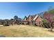 Charming brick home features a manicured lawn, mature trees, and classic architectural details at 149 Crown Glen Way, Stockbridge, GA 30281