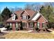 Beautiful two-story brick home with a well-manicured lawn and mature landscaping, showcasing classic design and curb appeal at 149 Crown Glen Way, Stockbridge, GA 30281