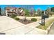 Well-manicured front yard of a two-story brick home with a long driveway and beautiful landscaping, showcasing suburban charm at 149 Crown Glen Way, Stockbridge, GA 30281