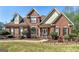 Charming two-story brick home with a manicured lawn and inviting front entrance with a portico at 149 Crown Glen Way, Stockbridge, GA 30281