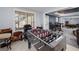 Bright game room with foosball table, natural light, and view into living area. Ideal for leisure and entertainment at 149 Crown Glen Way, Stockbridge, GA 30281