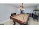 Spacious game room with a pool table, popcorn machine, and bar stools, perfect for entertaining guests at 149 Crown Glen Way, Stockbridge, GA 30281