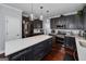 A spacious kitchen with a large island, stainless steel appliances, and dark cabinetry at 149 Crown Glen Way, Stockbridge, GA 30281