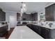 Stylish kitchen features dark wood cabinets, stainless steel appliances, and quartz countertops at 149 Crown Glen Way, Stockbridge, GA 30281