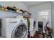 Convenient laundry room with front-load washer and dryer, storage shelves, and ample counter space for easy laundry tasks at 149 Crown Glen Way, Stockbridge, GA 30281