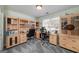 Home office featuring custom built-in shelves, cabinets, and two desks at 149 Crown Glen Way, Stockbridge, GA 30281