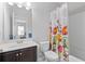 This bathroom is functional and stylish, featuring a vanity, toilet and shower with a decorative curtain at 326 Still Pine Bnd, Smyrna, GA 30082