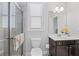 Well-lit bathroom featuring a glass-enclosed shower, and dark wood vanity with white countertop and modern fixtures at 326 Still Pine Bnd, Smyrna, GA 30082