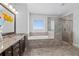 Bright bathroom with granite countertops, double sinks, soaking tub, and glass walk-in shower at 326 Still Pine Bnd, Smyrna, GA 30082