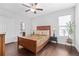 Bedroom featuring hardwood floors, a ceiling fan, and a sunlit window at 326 Still Pine Bnd, Smyrna, GA 30082