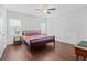 Bright bedroom featuring hardwood floors, a ceiling fan, and a comfortable queen-size bed at 326 Still Pine Bnd, Smyrna, GA 30082