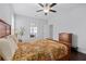Bright bedroom featuring hardwood floors, a ceiling fan, and a sunlit window at 326 Still Pine Bnd, Smyrna, GA 30082
