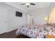Bright bedroom with ceiling fan, wood floors, and mounted television at 326 Still Pine Bnd, Smyrna, GA 30082