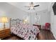 Comfortable bedroom with a ceiling fan, two windows, and a plush floral comforter set at 326 Still Pine Bnd, Smyrna, GA 30082