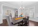 Elegant dining room with wainscoting, a modern chandelier, and a dark wood table at 326 Still Pine Bnd, Smyrna, GA 30082