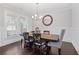 Elegant dining room with wainscoting, a modern chandelier, and a dark wood table at 326 Still Pine Bnd, Smyrna, GA 30082