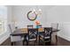 Elegant dining room with wainscoting, a modern chandelier, and a dark wood table at 326 Still Pine Bnd, Smyrna, GA 30082