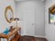 Welcoming entryway features a decorative mirror, wooden console table, and dark hardwood floors at 326 Still Pine Bnd, Smyrna, GA 30082