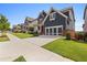 Charming two-story home featuring a well-manicured lawn and lush landscaping with blue siding and a two-car garage at 326 Still Pine Bnd, Smyrna, GA 30082