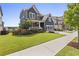 Charming two-story home featuring a well-manicured lawn and lush landscaping with blue siding and a welcoming porch at 326 Still Pine Bnd, Smyrna, GA 30082