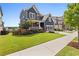 Charming two-story home featuring a well-manicured lawn and lush landscaping with blue siding and a welcoming porch at 326 Still Pine Bnd, Smyrna, GA 30082