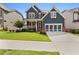 Charming two-story home with blue siding, a well-manicured lawn, and a two-car garage at 326 Still Pine Bnd, Smyrna, GA 30082