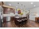 Open kitchen with stainless steel appliances and large island with barstool seating at 326 Still Pine Bnd, Smyrna, GA 30082