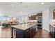 Open-concept kitchen with granite countertops, stainless steel appliances, and a large center island at 326 Still Pine Bnd, Smyrna, GA 30082