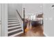 Open concept featuring hardwood floors, and a kitchen with granite countertops, a large island, and stainless steel appliances at 326 Still Pine Bnd, Smyrna, GA 30082