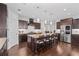 Modern kitchen with dark wood cabinets, granite countertops, stainless steel appliances, and a large center island at 326 Still Pine Bnd, Smyrna, GA 30082