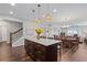 Open kitchen featuring a large island and view of dining area and staircase at 326 Still Pine Bnd, Smyrna, GA 30082