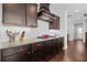 Chef's kitchen with sleek cabinetry, granite countertops, tiled backsplash, and modern gas cooktop at 326 Still Pine Bnd, Smyrna, GA 30082