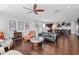 Spacious living room featuring hardwood floors, comfortable seating, fireplace, and seamless flow to kitchen at 326 Still Pine Bnd, Smyrna, GA 30082