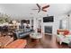 Open living space with hardwood floors, fireplace, comfortable seating, and bright natural light at 326 Still Pine Bnd, Smyrna, GA 30082