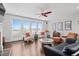 Bright living room with large windows, hardwood floors, comfortable seating, and decorative fireplace at 326 Still Pine Bnd, Smyrna, GA 30082