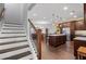 Open-concept home featuring stairs and a modern kitchen with granite countertops and stainless steel appliances at 326 Still Pine Bnd, Smyrna, GA 30082