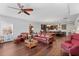 Open living room with wood floors, comfortable seating, and view to kitchen at 326 Still Pine Bnd, Smyrna, GA 30082
