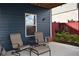 Covered patio with comfortable seating, perfect for relaxing and enjoying the outdoors with colorful flower bed at 326 Still Pine Bnd, Smyrna, GA 30082