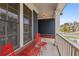Inviting front porch with red metal chairs, brick accents, and white railings on a home with navy blue siding at 326 Still Pine Bnd, Smyrna, GA 30082