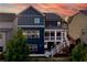 Stunning rear exterior of a navy two-story home with screened in porch and deck at 326 Still Pine Bnd, Smyrna, GA 30082