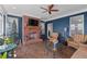 Cozy sunroom with a brick fireplace, TV, comfortable seating, and lots of natural light at 326 Still Pine Bnd, Smyrna, GA 30082