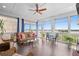 Relaxing sunroom with a ceiling fan, plenty of windows, and comfortable seating area at 326 Still Pine Bnd, Smyrna, GA 30082
