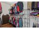 Walk-in closet with lots of storage for hanging clothes on rods and folding clothes on shelves at 326 Still Pine Bnd, Smyrna, GA 30082