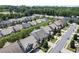 Expansive aerial view of a suburban neighborhood featuring numerous homes, mature trees, and well-maintained landscaping at 4452 Thach Ave, Sugar Hill, GA 30518