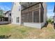 House exterior with a fenced yard and screened-in porch attached to the back at 4452 Thach Ave, Sugar Hill, GA 30518
