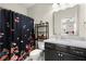 Cozy bathroom with a shower and floral shower curtain, granite counters, and storage at 4452 Thach Ave, Sugar Hill, GA 30518