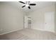 Cozy bedroom with a view to another room, featuring a ceiling fan and neutral carpet at 4452 Thach Ave, Sugar Hill, GA 30518