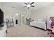Bright bedroom features a ceiling fan, daybed, and adjacent bathroom for convenience at 4452 Thach Ave, Sugar Hill, GA 30518